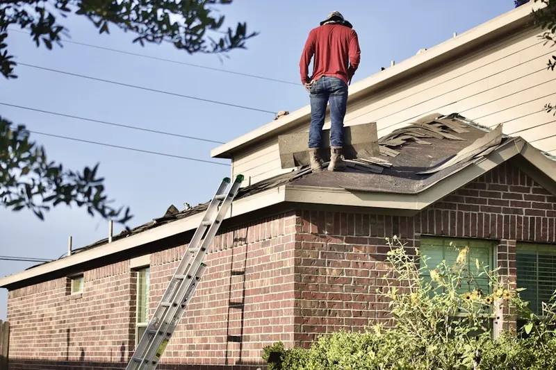Professional roofer working on a residential roof in Ocean Pointe